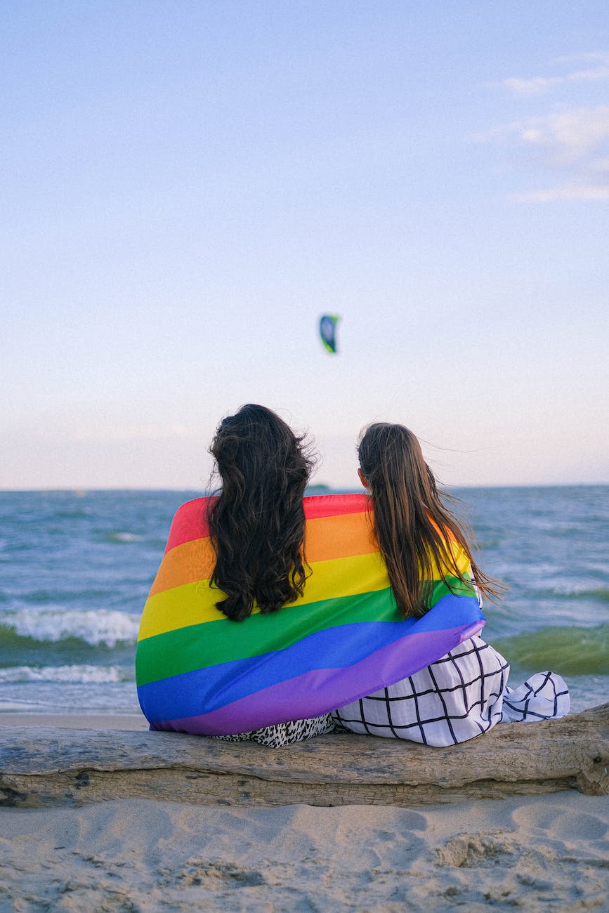 a couple wrapped in rainbow flag